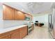 Bright kitchen with stainless steel appliances, wood cabinets, and white quartz countertops at 6111 Courtside Dr # 61, Bradenton, FL 34210