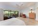 Bright main bedroom with vaulted ceilings, ceiling fan, and sliding glass doors at 6111 Courtside Dr # 61, Bradenton, FL 34210