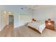Bright main bedroom features light blue walls, light wood floors, and a spacious closet at 6111 Courtside Dr # 61, Bradenton, FL 34210