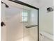 Shower with glass door and white tile at 6111 Courtside Dr # 61, Bradenton, FL 34210