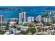 Beautiful aerial view of modern residential buildings with rooftop pools, framed by a vibrant bay at 626 Rawls Ave # 626, Sarasota, FL 34236