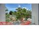 Inviting balcony with modern chairs offers a serene view of lush greenery and the neighborhood at 626 Rawls Ave # 626, Sarasota, FL 34236