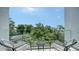 Balcony featuring two chairs, a small table, and views of trees and the surrounding area at 626 Rawls Ave # 626, Sarasota, FL 34236