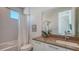 Bright bathroom features a bathtub, sleek vanity, and contemporary finishes at 626 Rawls Ave # 626, Sarasota, FL 34236