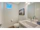 Half bathroom with sink, toilet, and modern mirror at 626 Rawls Ave # 626, Sarasota, FL 34236