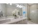 Modern bathroom showcases a double sink vanity, glass-enclosed shower, and contemporary finishes at 626 Rawls Ave # 626, Sarasota, FL 34236