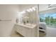 Modern bathroom features a double sink vanity, sleek fixtures, and a view to the bedroom at 626 Rawls Ave # 626, Sarasota, FL 34236