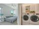 Bright bedroom includes a bed, laundry room and a view of the outside at 626 Rawls Ave # 626, Sarasota, FL 34236