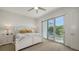 Bright bedroom with queen bed, balcony access, and ceiling fan at 626 Rawls Ave # 626, Sarasota, FL 34236