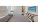 Cozy bedroom features a comfortable bed, stylish furnishings, and a view into the bathroom at 626 Rawls Ave # 626, Sarasota, FL 34236