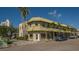Inviting corner building with coffee shop and retail featuring outdoor seating and lush tropical landscaping at 626 Rawls Ave # 626, Sarasota, FL 34236