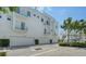 Modern condominium building featuring multiple balconies, garage parking, and manicured landscaping at 626 Rawls Ave # 626, Sarasota, FL 34236