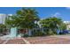 Charming two-story retail building featuring a unique facade, lush trees, and inviting storefront windows at 626 Rawls Ave # 626, Sarasota, FL 34236