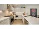 Bright kitchen featuring white cabinetry, quartz countertops, stainless steel appliances, and wood flooring at 626 Rawls Ave # 626, Sarasota, FL 34236