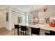 Contemporary kitchen features a central island with seating and pristine white countertops and stylish cabinetry at 626 Rawls Ave # 626, Sarasota, FL 34236