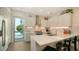 Modern kitchen equipped with stainless steel appliances and sleek white countertops, along with barstool seating at the island at 626 Rawls Ave # 626, Sarasota, FL 34236