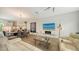 Bright living room showcases modern decor, including an entertainment center with fireplace, plus an open layout to kitchen and dining area at 626 Rawls Ave # 626, Sarasota, FL 34236