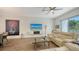 Bright living room features contemporary design elements and an entertainment center, complemented by a modern ceiling fan at 626 Rawls Ave # 626, Sarasota, FL 34236