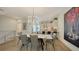 Stylish dining area with modern lighting opens to a sleek kitchen, creating an inviting and contemporary living space at 626 Rawls Ave # 626, Sarasota, FL 34236