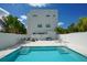Community pool featuring clear blue water, deck chairs and a modern building with a white fence surround at 626 Rawls Ave # 626, Sarasota, FL 34236
