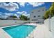 Sparkling community pool with modern tile, surrounded by lounge chairs and a clean, contemporary building facade at 626 Rawls Ave # 626, Sarasota, FL 34236