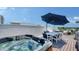 Luxury rooftop deck features a hot tub, dining area with umbrella, and outdoor seating with beautiful views at 626 Rawls Ave # 626, Sarasota, FL 34236