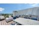 Modern rooftop deck with a dining set, outdoor grill, and a cozy fire pit perfect for entertaining at 626 Rawls Ave # 626, Sarasota, FL 34236