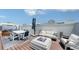 Elegant rooftop deck includes a firepit, hot tub, dining table, and outdoor seating for luxurious entertaining at 626 Rawls Ave # 626, Sarasota, FL 34236