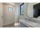 Stylish bathroom featuring a glass shower, window, and vanity with marble countertop at 670 Old Compass Rd, Longboat Key, FL 34228