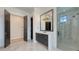 Stylish bathroom featuring a single vanity, glass shower, marble floors, and modern fixtures at 670 Old Compass Rd, Longboat Key, FL 34228