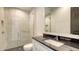Modern bathroom featuring a sleek vanity with dark countertop and a spacious glass-enclosed shower at 670 Old Compass Rd, Longboat Key, FL 34228