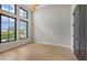Bedroom with ample windows, tall ceilings, wood floors, recessed lighting and dark door at 670 Old Compass Rd, Longboat Key, FL 34228