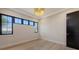 Bright bedroom with three windows, recessed lighting, wood floors, and neutral decor at 670 Old Compass Rd, Longboat Key, FL 34228