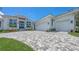 Beautiful home exterior featuring a patterned driveway and well-manicured landscaping at 670 Old Compass Rd, Longboat Key, FL 34228