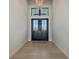 Welcoming entryway featuring a decorative chandelier and a double-door entrance at 670 Old Compass Rd, Longboat Key, FL 34228
