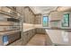 Modern kitchen featuring stainless steel appliances, stone countertops and island at 670 Old Compass Rd, Longboat Key, FL 34228