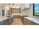 Well-equipped kitchen featuring an island, stone countertops, and sleek, stainless steel appliances at 670 Old Compass Rd, Longboat Key, FL 34228