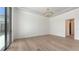 Bright room with hardwood floors, modern chandelier, and large windows with views of the outdoor kitchen at 670 Old Compass Rd, Longboat Key, FL 34228