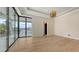 Bright living room features large glass doors with balcony and view of canal at 670 Old Compass Rd, Longboat Key, FL 34228