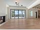 Bright living room with a fireplace, large sliding glass doors, and waterfront views at 670 Old Compass Rd, Longboat Key, FL 34228