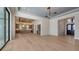 Expansive living area showcasing kitchen access, hardwood floors, and a stylish bar at 670 Old Compass Rd, Longboat Key, FL 34228