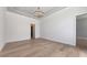 Spacious and bright room with beautiful floors and a modern chandelier, ready for your personal touch at 670 Old Compass Rd, Longboat Key, FL 34228