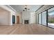 Cozy living room with a modern fireplace, hardwood floors, and recessed lighting at 670 Old Compass Rd, Longboat Key, FL 34228