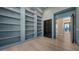 Spacious office features custom built-in shelving, light hardwood floors, and an open door to a foyer at 670 Old Compass Rd, Longboat Key, FL 34228
