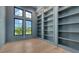 Office space with custom built-in bookshelves, light hardwood floors, and an abundance of natural light at 670 Old Compass Rd, Longboat Key, FL 34228