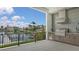 Beautiful outdoor kitchen with stainless steel appliances overlooking the waterfront at 670 Old Compass Rd, Longboat Key, FL 34228