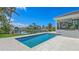 Gorgeous pool with lush landscaping, patio, waterfront view, and canal access at 670 Old Compass Rd, Longboat Key, FL 34228