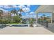 Outdoor pool with a waterfront view of a boat dock and lush palm trees and sky at 670 Old Compass Rd, Longboat Key, FL 34228