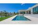 Backyard pool with waterfront views, patio, lush tropical foliage, and dock at 670 Old Compass Rd, Longboat Key, FL 34228
