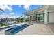 Gorgeous patio features an outdoor kitchen, plunge pool, and serene waterfront views at 670 Old Compass Rd, Longboat Key, FL 34228